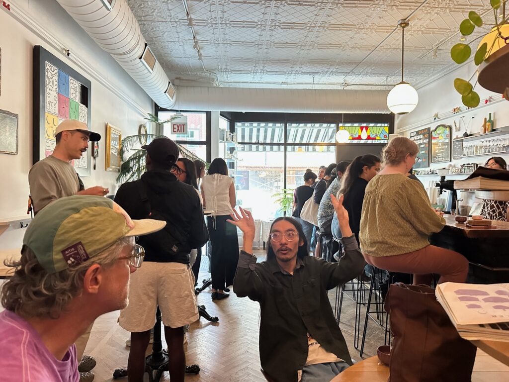 A packed cafe full of people talking during a Chicago Matcha Club field trip